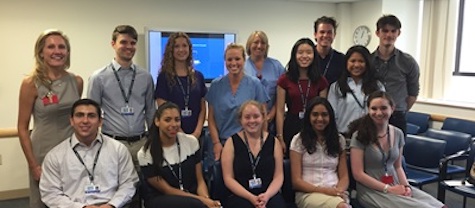 fourteen men and women standing and sitting