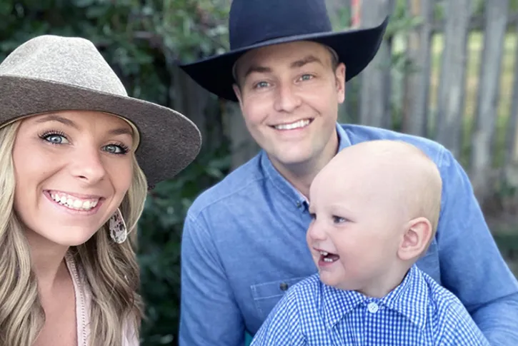 mom and dad wearing cowboy hats with little child
