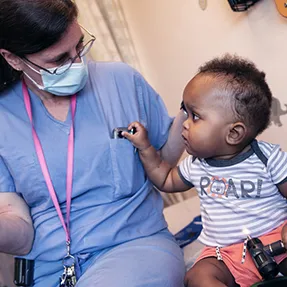Clinician talks to young girl patient