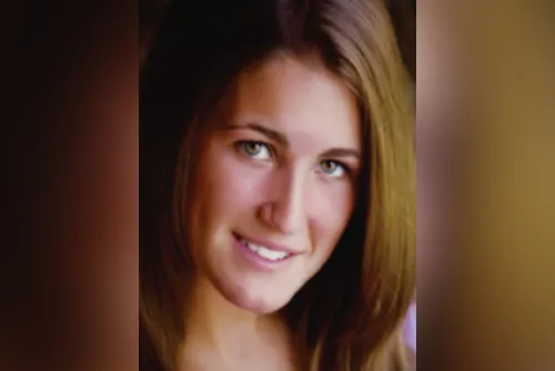 Smiling teenage female looks at camera for portrait